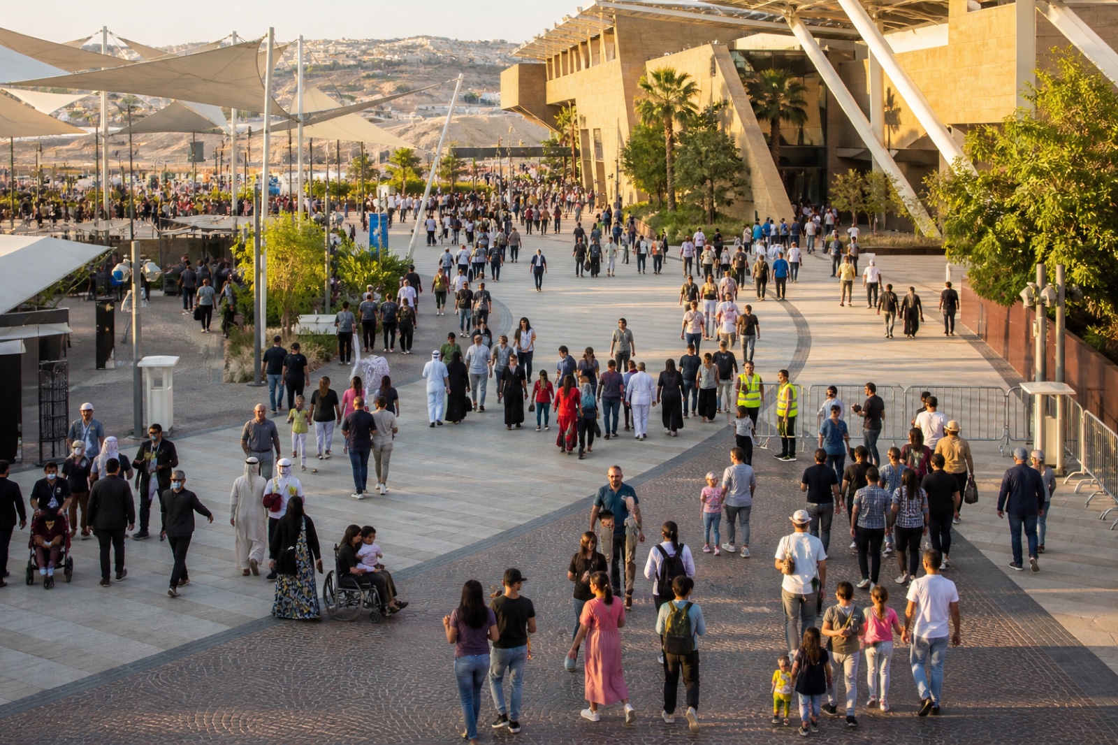 Families, staff, and visitors moving through a large civic plaza during a public event